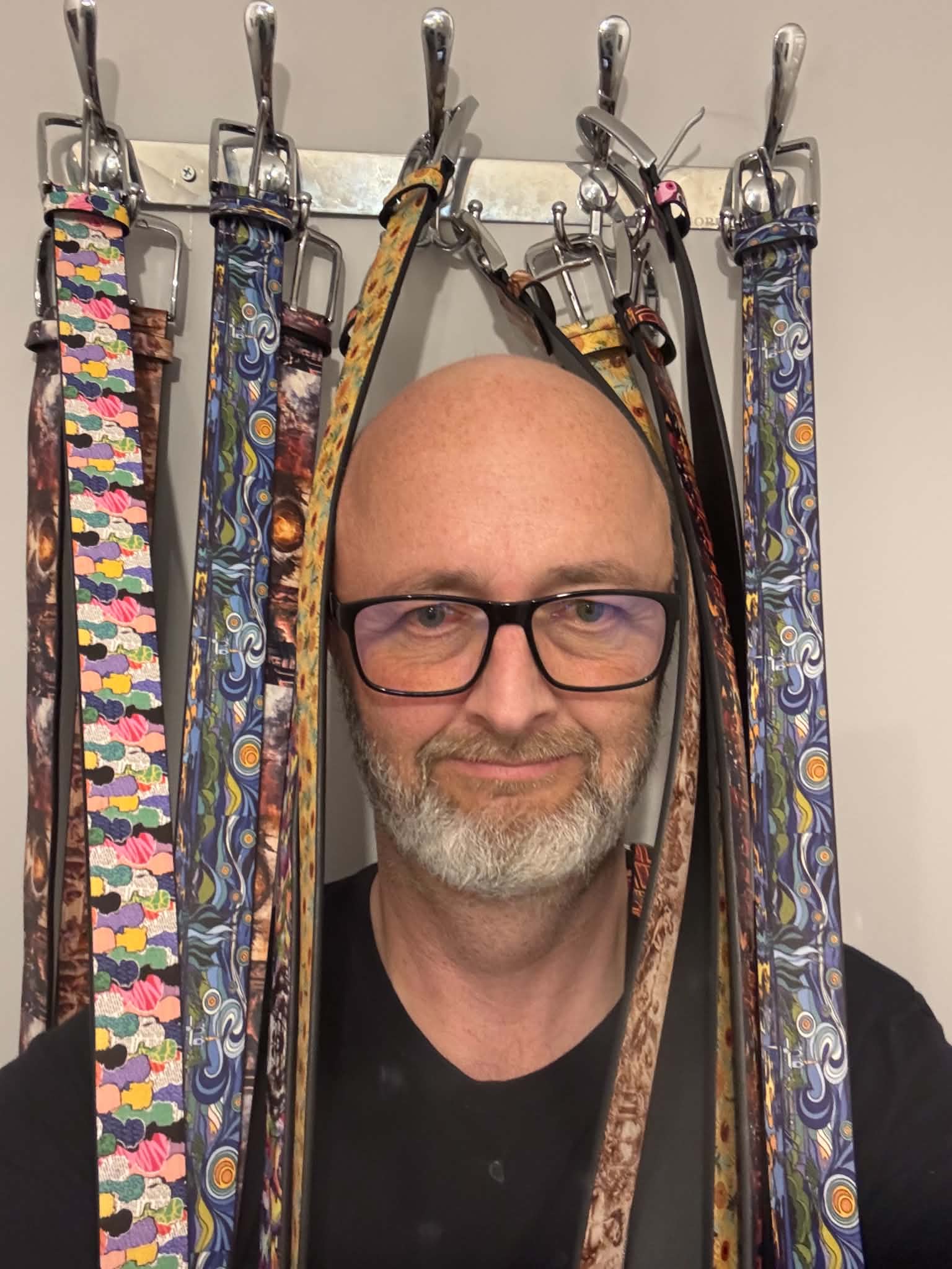 Duncan, founder of Loop Culture, framed by hanging belts